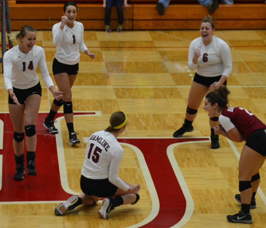 Hamline volleyball celebrate a point scored in the fourth set of their homecoming game  against Augsburg: (left to right)  junior Gabriella Feldt, senior Caitlyn Gottwald, senior co-captain Paige Walters, junior Vassi Prattas and senior co-captain Lynsey Reimer.