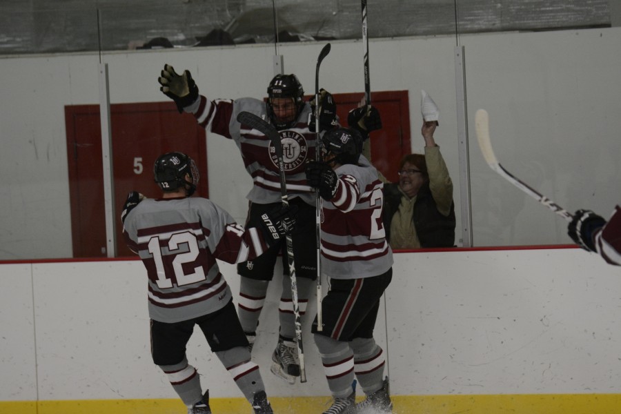 Junior forward and assistant team captain Kevin Novakovich (11) celebrates with the Pipers.