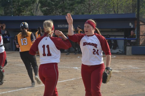 Senior Alli Ruter (left) and Casey Anderson (right) hi-five each other on May 1, 2015.