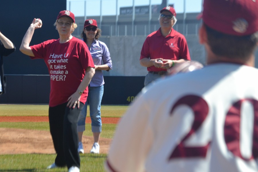 Hamline Universitys President Linda Hanson throws out the first pitch to junior pitcher Aaron Stoneberg before the first ever game played at CHS Field on April 11, 2015.