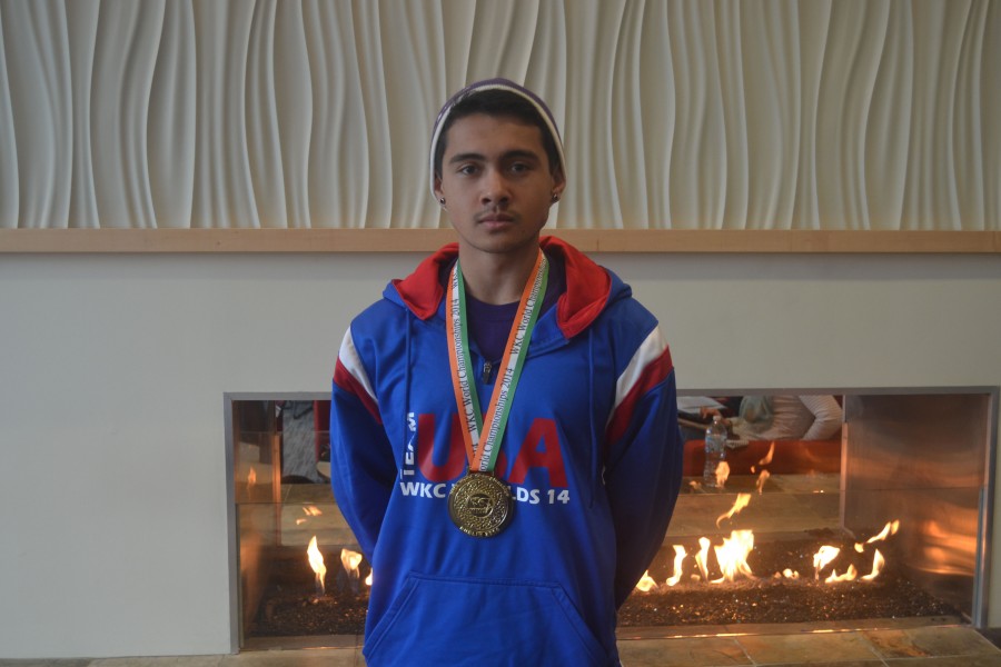 Sophomore kickboxer Zack Koppa poses with his gold medal from the 2014 WKC World Championships.