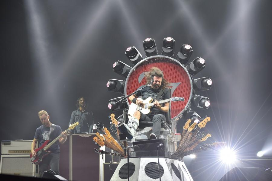 Foo Fighter Dave Grohl headbanging and strumming his guitar while performing for 15,000 fans.