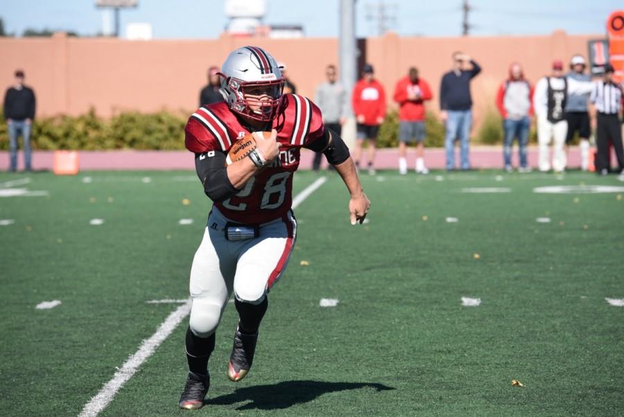 Senior co-captain Austin Duncan runs the ball forward during Oct.2 homcoming game against St. John’s. Duncan ran for 78 yards and a touchdown. Duncan broke the Hamline all-time rushing record as a junior against St. John’s last year.