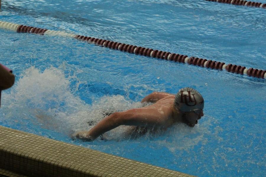 Junior Ethan Ross competes in the 100 meter butterfly on Saturday, Nov. 7.