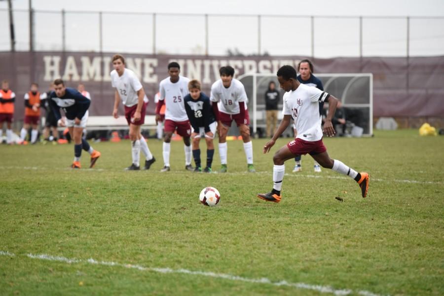 Senior Abbai Habte strides to score the game winning penalty kick against Bethel on Oct. 27. Habte was fouled in the box with two minutes left in the game to push the Pipers to a playoff spot.
