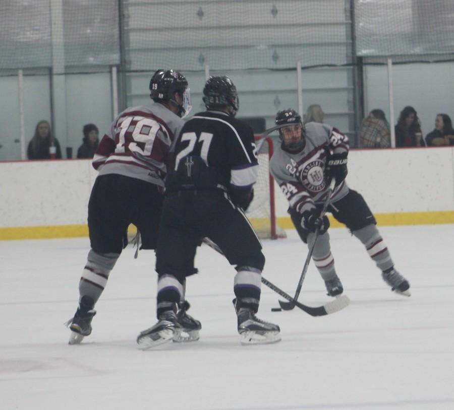 Junior forward Andrew Paras advances the puck against the Tommies.