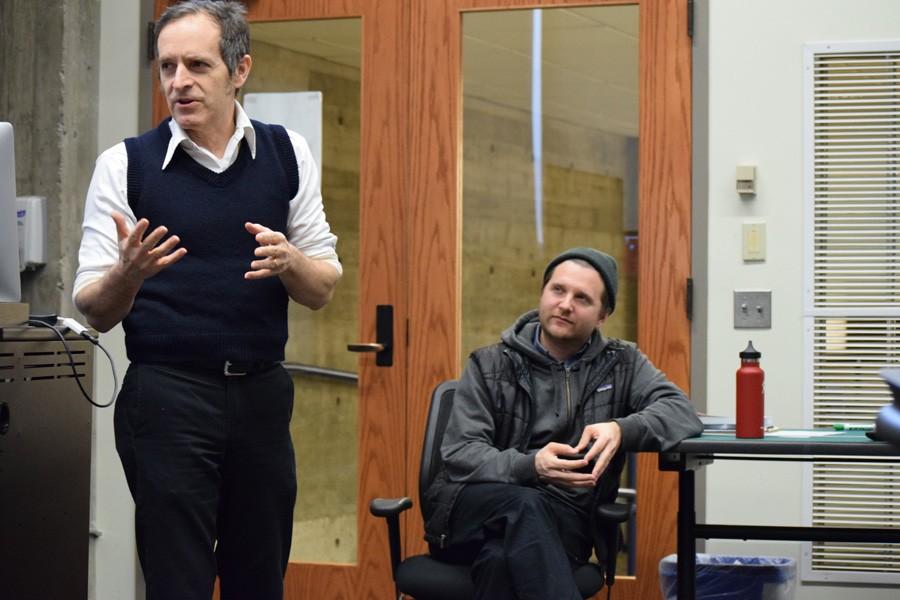 Left, visiting filmmaker Cory McAbee speaks to a group of students and faculty in Bush Memorial Library on Friday, Feb. 5. Right, adjunct professor Richard Pelster-Wiebe watches and listens intently.