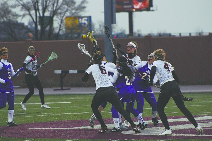 Jordan Nielsen (#6), Maddie Brown (#4) and Rachel Todd (#7) fight for possession of the ball at the lacrosse home opener on April 5.