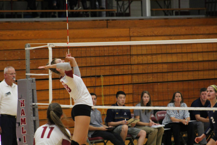 Senior outside hitter Julia Zolnosky goes up for a spike attempt against Concordia.
