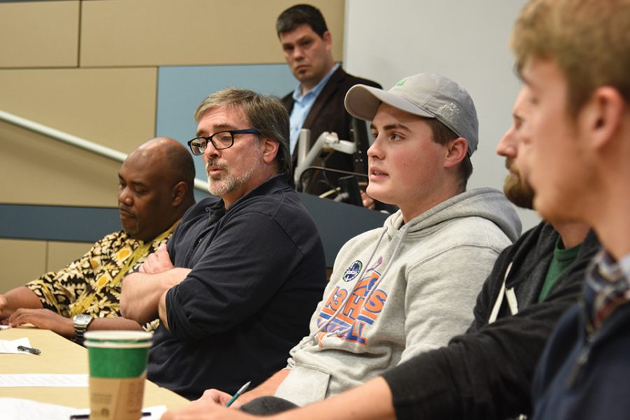 Senior Austin Fuller, right, discusses the idea of dominance within manhood while Professor Mike Reynolds, left, looks on.