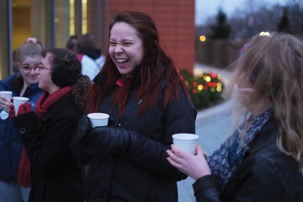 Senior Adrianna Anderson laughs with friends at the Lighting of the Trees. 