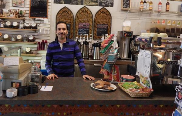 Owner Saed Kakish stands behind the counter at Cahoots Coffee Bar. He used to be a customer at the shop before taking over in 1997.