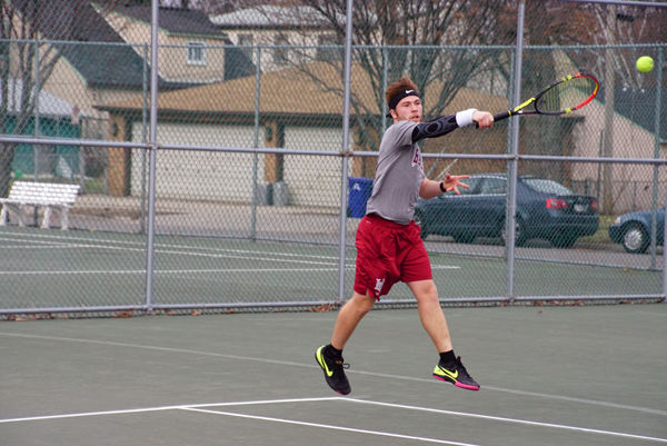 Junior Brandon Kuether returns a ball during one of his two singles matches last Saturday. Kuether lost both of his matches, but Hamline managed to split their matches on the day.