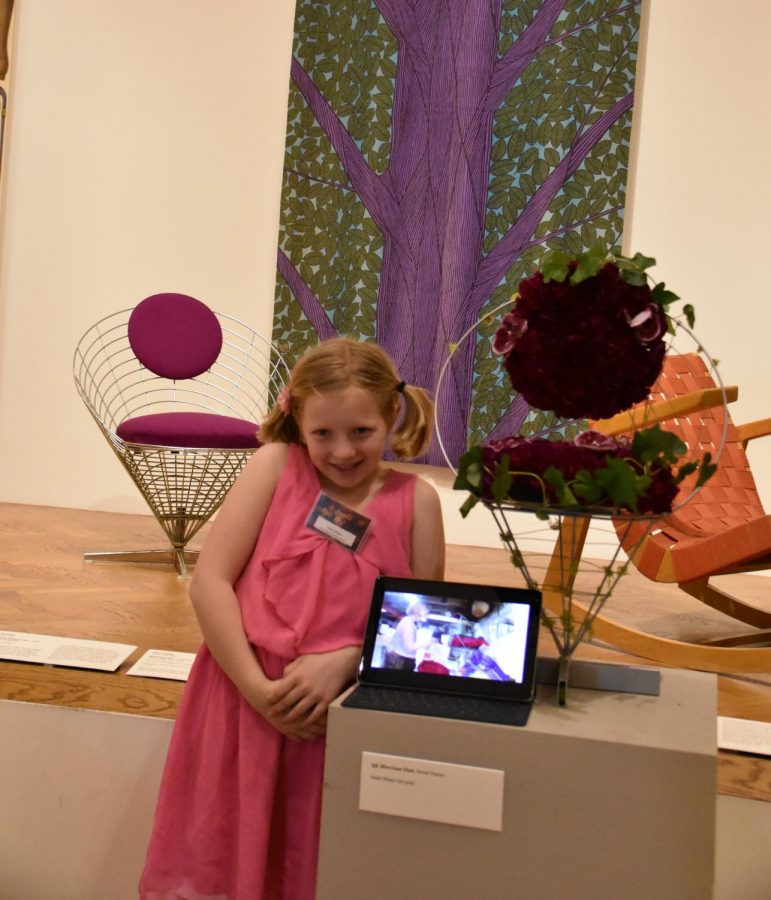 Violet Wilson stands beside her finished piece and the chair that inspired it, showing off the timelapse to prove she did it all by herself. 