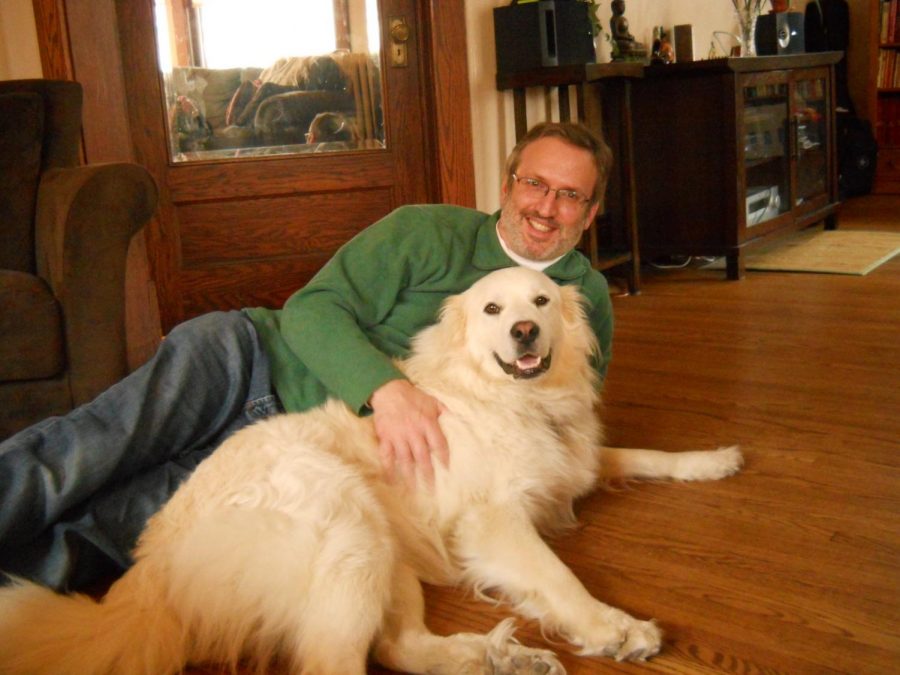 Professor Mark Berkson and his beloved dog, Duncan, cuddling together.