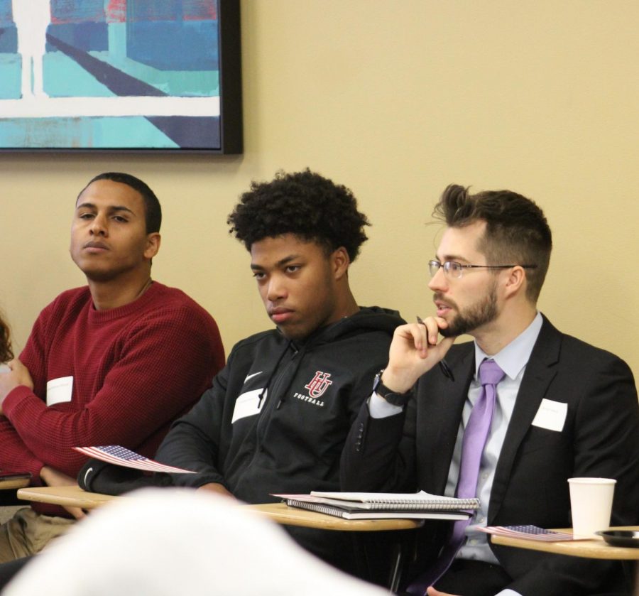 Hassan Mahmoud Jiddah, Manny Moton and Devan Flaherty listen intently to ongoing discussion.