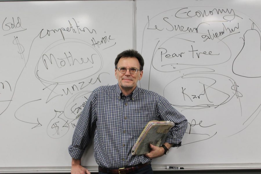 Mark Olson stands in front of his signature board of notes. 