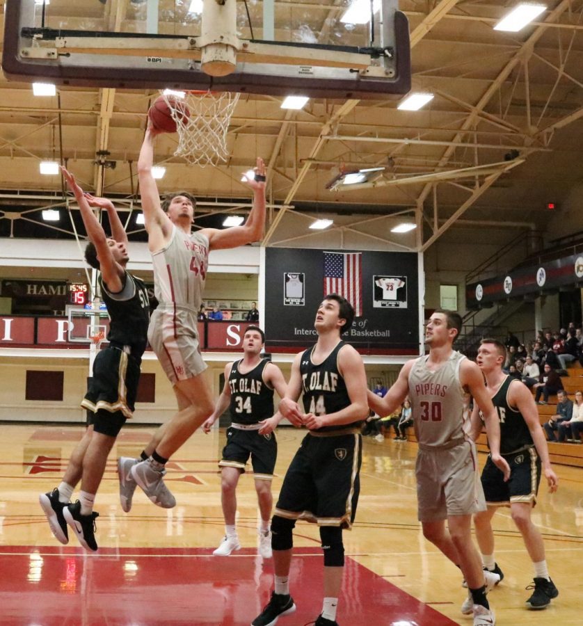 Ethan Scheuring, senior forward, scores during an opening in the first half of a mens basketball game.