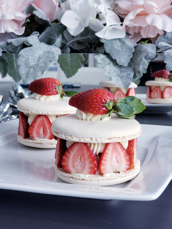 Extra large macaron shells make a “mac cake” with frosting and fresh berries inside. 