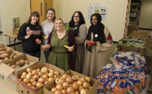 Feed Your Brain members and volunteers at one of their monthly pop-up pantries. Pictured from left to right, sophomore Maggie Bruns, senior Emma Kiley, senior Maddie Guyott, senior An Garagiola and sophomore Najma Omar.