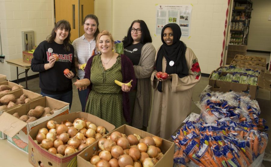 Feed Your Brain members and volunteers at one of their monthly pop-up pantries. Pictured from left to right, sophomore Maggie Bruns, senior Emma Kiley, senior Maddie Guyott, senior An Garagiola and sophomore Najma Omar.