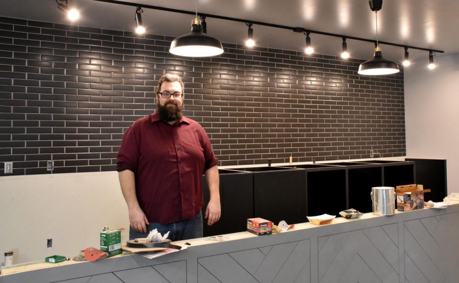 Owner Micah Sveja stands behind the future bar, waiting for its granite countertop. 