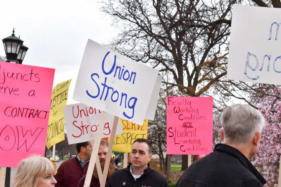 Adjunct supporters hold up signs, many of them reading, “Union Strong”.