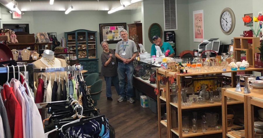 From left, owner Melody Luepke stands with volunteer John Sponsel and her husband, Charlie Luepke in the newly opened Flying Pig Thrift.