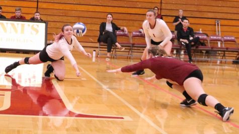 Senior Morgan Coleman and first-year Maggie Gavic dive to keep the ball in the air during a hotly contested match against Gustavus Adolphus on Oct. 5.