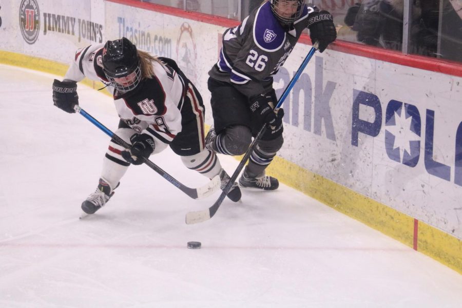 Senior Jordan Hansen attempts to steal the puck from an opponent during a Feb. 14 game against St. Thomas.