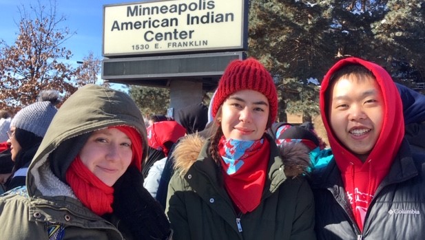 From left, Hamline students Fances Verner (junior), Emily Mckenzie (first-year) and Plykue Thao (senior)  stand outside the Minneapolis American Indian Center. They and other marchers donned red in support of missing and murdered indigenous women (MMIW).
