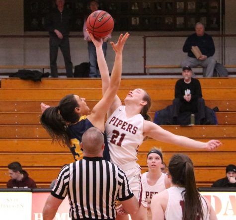 First-year Lydia Lecher goes up for the tip-off to start off the game against Concordia on Feb. 25.