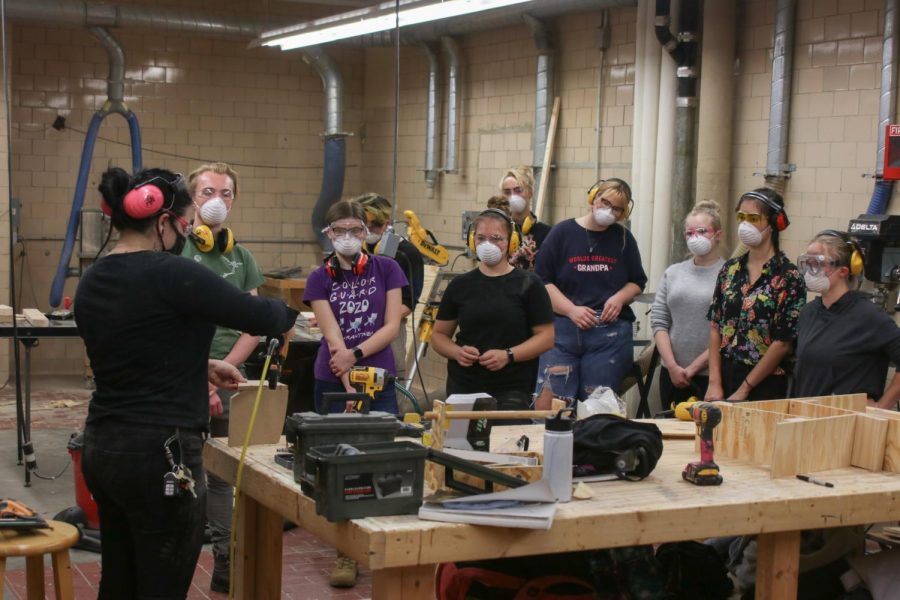 A class taking place in person in the woodshop
