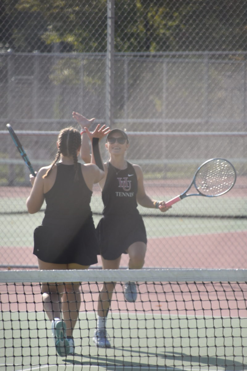 Doubles partners Natalie Randall and Christine Muller celebrate en route to an 8–2 win in the first set.