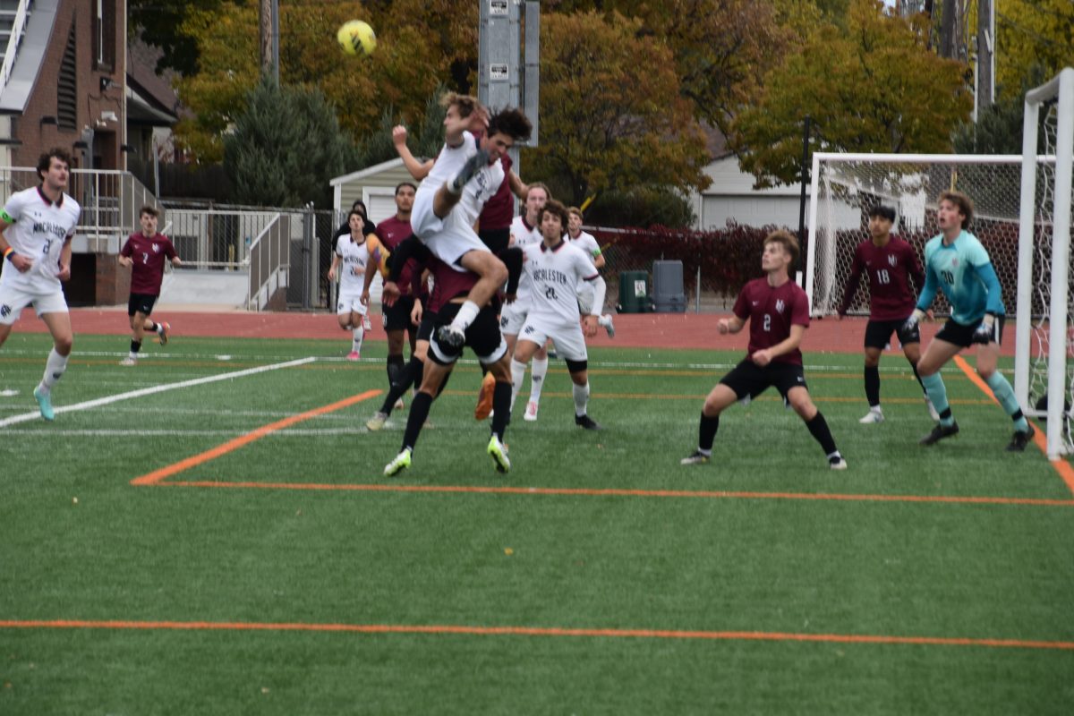 Two players attempt to get the first touch on an air ball in Hamline’s 3–0 loss to Macalester.