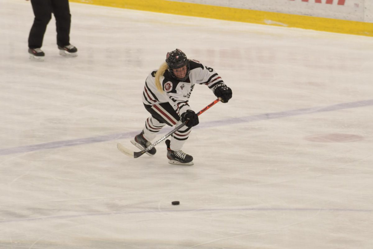 A Hamline skater moves the puck through the neutral zone.