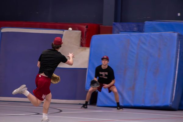 Pipers get some infield work indoors at Walker Fieldhouse.