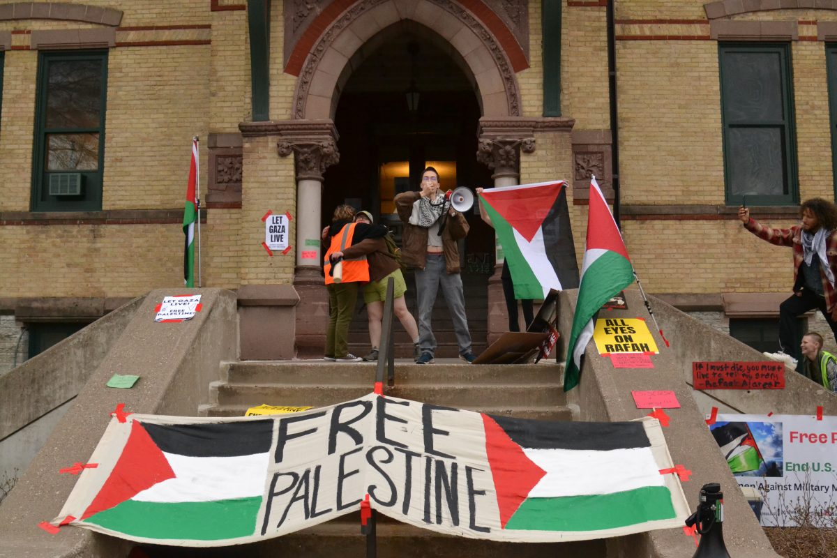 Pro-Palestinian+protestors+exited+Old+Main+after+their+29+hour+long+occupation+of+the+building.+June+Gromis+took+the+megaphone+to+declare+to+everyone+on+Old+Main+lawn+that+they+received+their+requests+and+will+be+meeting+with+Hamline+Administration+to+further+discuss+their+demands.+Students+from+left+to+right%3A+Genavieve+Billiet%2C+Ivy+Evrard%2C+June+Gromis%2C+Clare+Friar+and+Lydia+Meier.