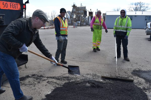 Students had the opportunity to shovel asphalt into a pothole during their tour of the Saint Paul asphalt plant, the first tour the facility has hosted.