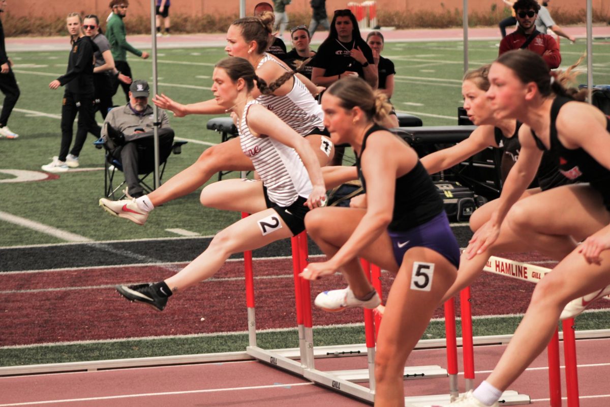 Junior Aliyah Robran (#1) and senior Gabrielle Hannah (#2) running in the Women's 100 meter hurdles event. Robran finished with a time of 16.28 seconds and Hannah finished with a time of 16.56 seconds.