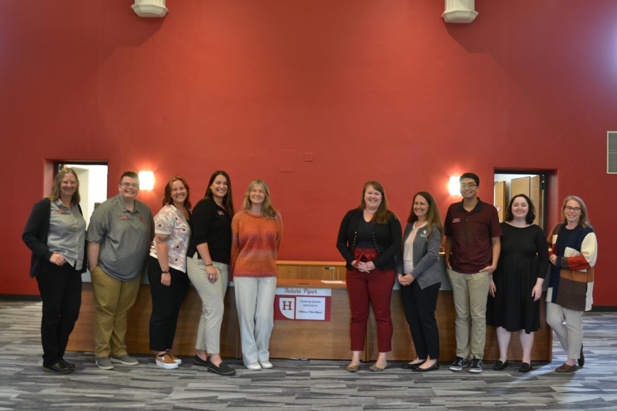 Posing in their new office, located at The Old Library in Giddens Learning Center, (from left to right) is Hamline Experience Coordinator Deb Ahlquist, Transfer Admissions Counselor Dawson Shanley, Admissions Counselors Sophie Taylor, Elle Biggins and Marquesa Galvin, Associate Director of Admissions Kaia Sherburne, Director of Undergraduate Admission Jen Olsen Krengel, Admissions Counselor Alex Aguirre, Admissions Operations Coordinator Zee Slater and Director of Enrollment Systems and Operations Holly Collins.