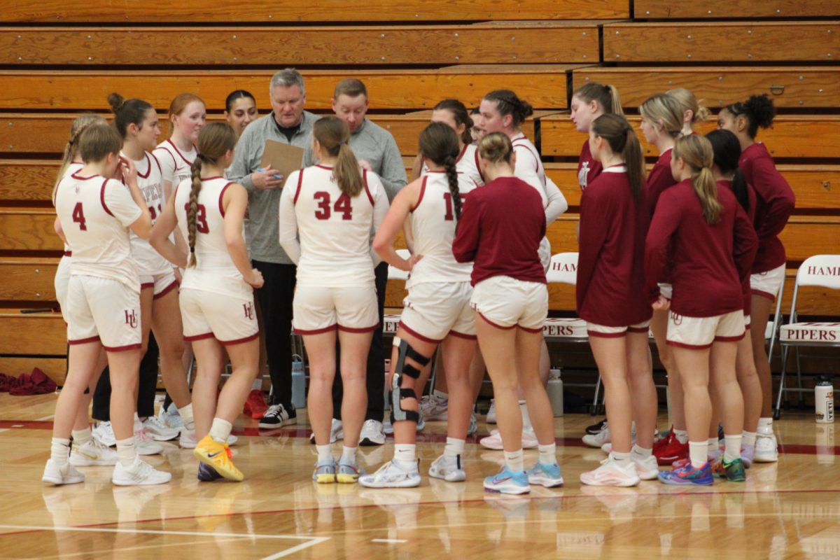 Hamline women's basketball gathers around during a time-out in their game against UW-Superior.