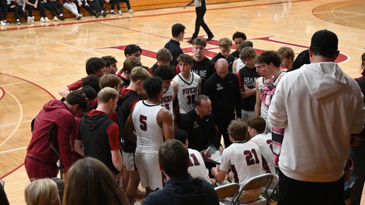 Head Coach Jim Hayes talking to the team during a timeout huddle.