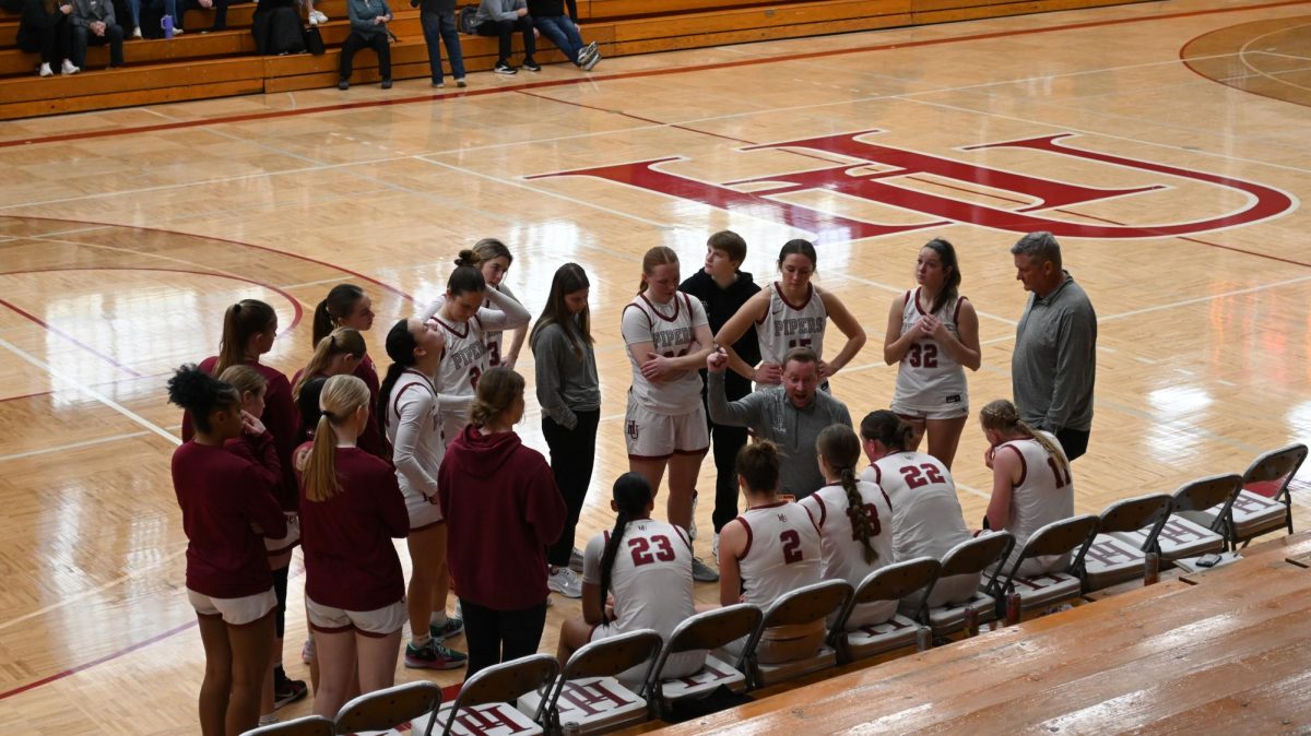 Head Coach Joshua Hersch delivers a mid-game talk to the team during a timeout in the 3rd quarter.