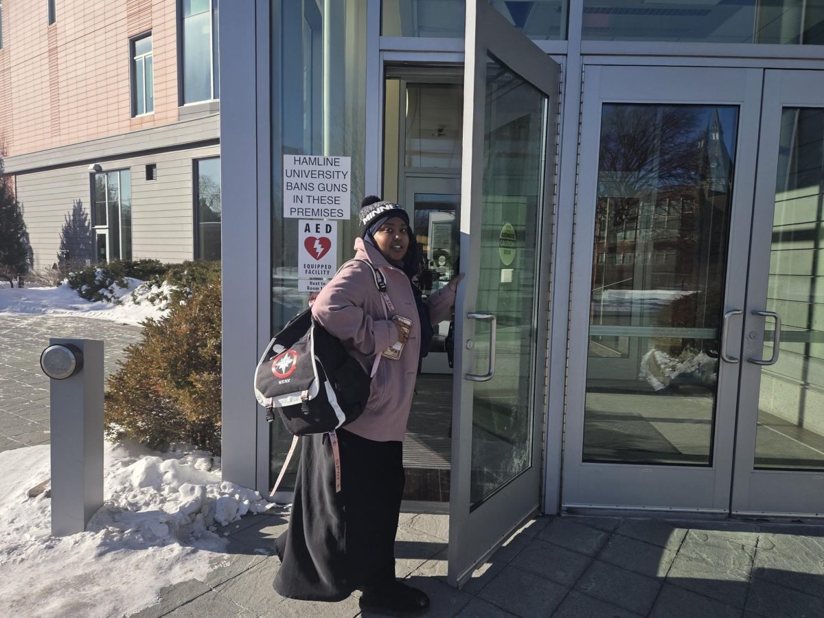 First-year Subeydo Ahmed using the allowed door at Anderson after locked doors restrictions came into place.
