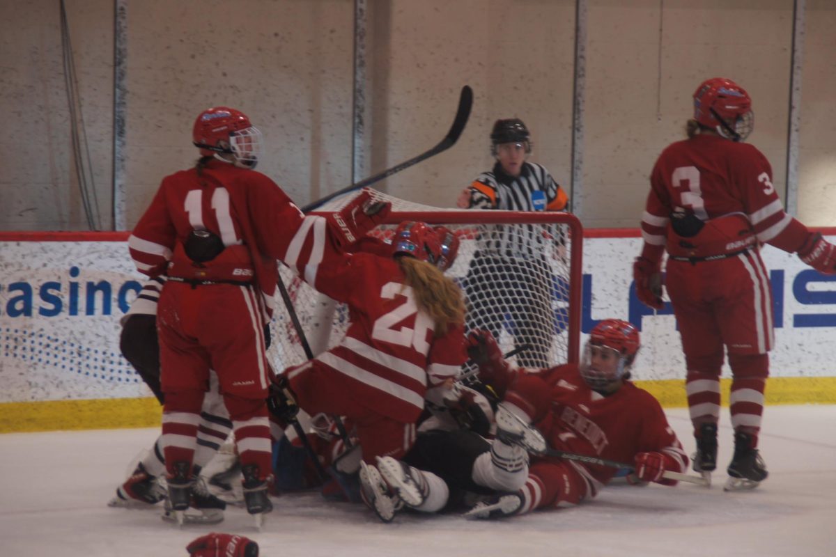 Pipers and Bennies alike form a mountain of bodies in a frantic scramble at the goalpost, allowing the Pipers to score their fifth point of the game.