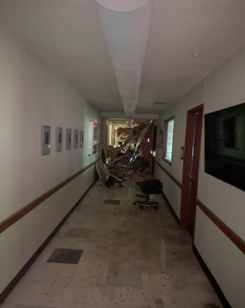 The an interior hallway containing labs, offices, and the wreckage where a bus crashed through the wall.